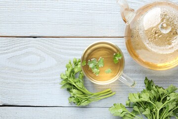 Healthy parsley tea on grey wooden table, flat lay with space for text. Detox drink