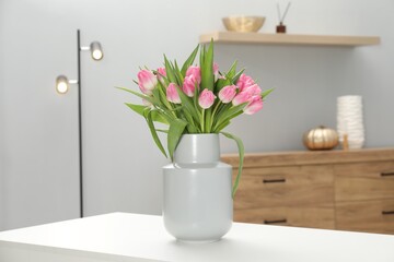 Bouquet of beautiful tulips in vase on white table indoors