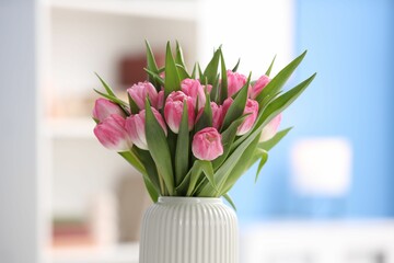 Bouquet of beautiful tulips in vase indoors, closeup