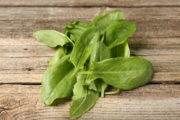 Fresh green sorrel leaves on wooden table, closeup