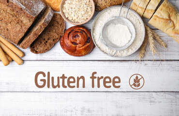 Gluten-free oat flour in bowl and different baked products on white wooden table, top view
