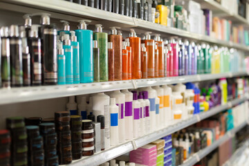 Colorful fashionable modern showcase in cosmetic boutique with variety of hair care products