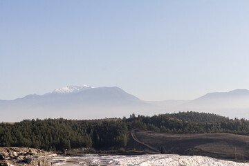 A majestic mountain in Turkey with snow-capped peaks, rising above the surrounding landscape.