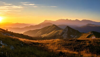 Mountain ranges and hills of forests and lakes during golden hour and a bright sky