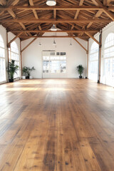 Sunlit industrial studio space with wooden floors and high ceilings