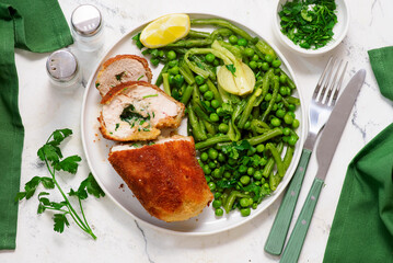 Chicken Kiev with green vegetables, peas and green beans