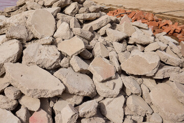There are numerous piles of concrete debris observable at the busy construction site right now