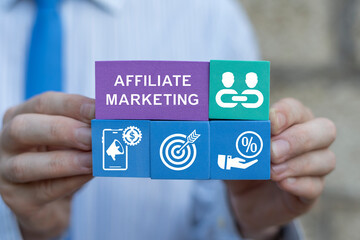 Business person holding colorful blocks with icons sees text: AFFILIATE PROGRAM. Affiliate Marketing Program Concept. Partnership marketing in social media. Refer a friend concept.