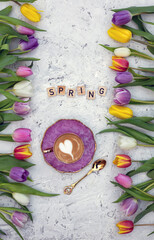 Beautiful spring background. Cup with coffee with tulips. Tulips background.
