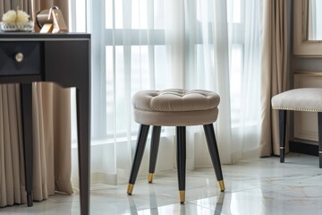 Cozy upholstered stool by a bright window in a modern room with elegant decor