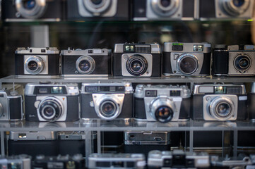 Analog vintage photo cameras behind the shop window