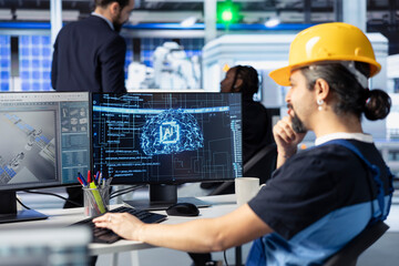 Engineer training AI models at workstation in solar panel production facility to identify...
