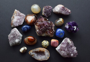 Beautiful purple drusy amethysts, labradorites and lapis lazuli on a dark background. Healing...