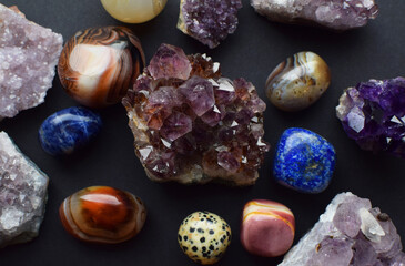 Beautiful purple drusy amethysts, labradorites and lapis lazuli on a dark background. Healing...