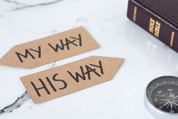 Jesus Christ's way of life, follow God. Inspirational handwritten text on paper arrows with holy...