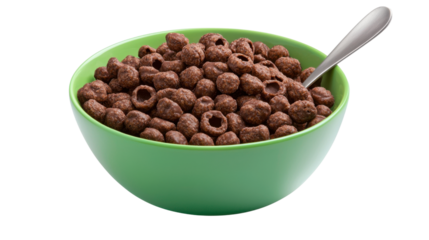 A bowl filled with crunchy chocolatey cereal pieces accompanied by a silver spoon set against a vibrant green background