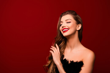 Photo of joyful smiling lady with closed eyes touch soft brown hairstyle over red color background