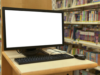 A public computer station in a library with a blank monitor screen, keyboard, and mouse on a wooden...