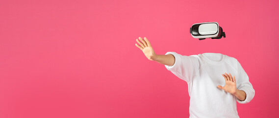 A person is engaging with virtual reality technology using a headset, fully immersed in a digital environment. The vibrant background enhances the technological ambiance.