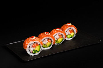 Delicious Fresh Salmon Sushi Rolls Presenting Exquisitely on a Black Background