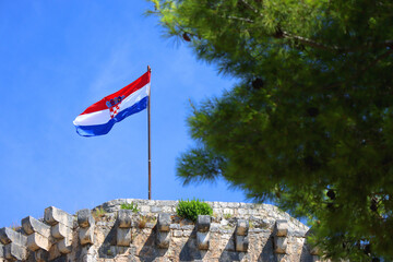 Historical Kamerlengo Fortress in Trogir, Croatia and Croatian flag. 