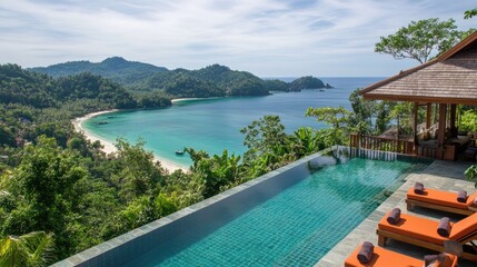Obraz premium Resort-style infinity pool overlooking a tropical beach with sun loungers neatly arranged.