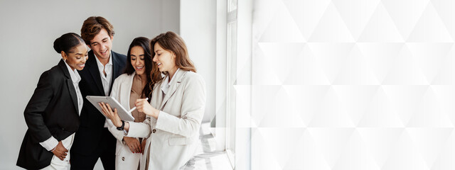 Entrepreneur businesswoman discussing new business project with her multiracial business team, using digital tablet in office, panorama with free space
