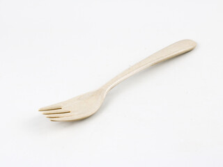 A beige plastic fork isolated - on white background