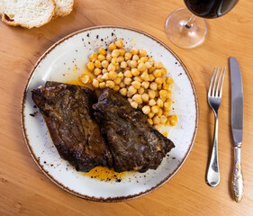 Roast whole pork knuckle served with chickpea on plate