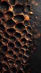 Abstract golden honeycomb pattern emerging from dark background
