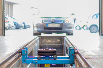 A car enters the inspection lane at the car technical inspection station. Technical inspection of the car in the workshop.