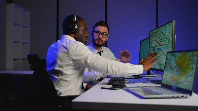 Logistics dispatchers coordinating freight shipments in real-time