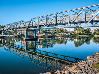 The steel truss footbridge over Maribyrnong River connecting Footscray and Kensington. The...