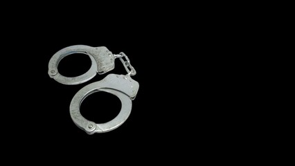 iron handcuffs on black background isolation. criminal concept illustration