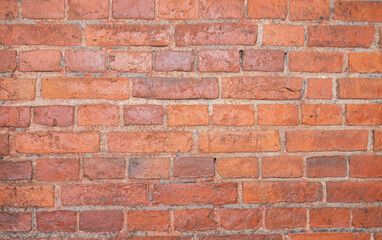 Red brick wall texture background with weathered bricks