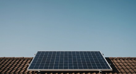 Naklejka premium Solar Panel on a Roof Under a Clear Blue Sky