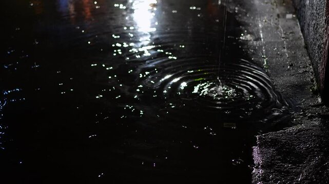 Walker avoiding puddles on a rainy night in Berlin