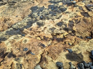 Sulfur and other minerals creating colorful patterns on volcanic rocks in Iceland