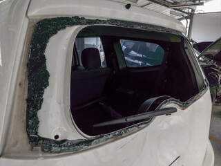 The glass of the trunk of a car was broken due to an accident being hit from behind