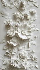 Intricate white bas-relief sculpture of flowers on a wall  -