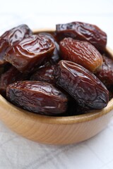 Tasty dried dates on white table, closeup
