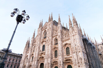Duomo cathedral in Milan, Italy with intricate gothic architecture and stunning marble facade