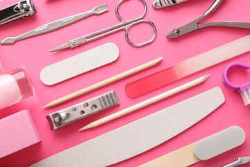 Set of different manicure tools on bright pink background, flat lay