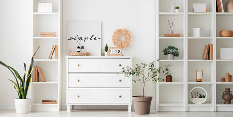 Aroma diffusers on chest of drawers and shelving unit in interior of living room