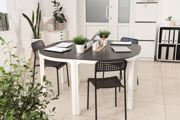 Interior of modern office with workplace and plants