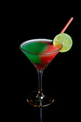 Frozen cocktail with lime garnish on black background
