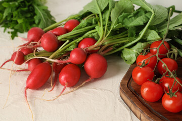 Fresh radish and tomatoes on light background