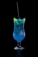 Blue Lagoon cocktail in a glass on a black background
