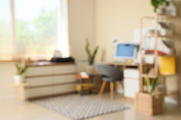 Blurred view of office with workplace and printer on commode