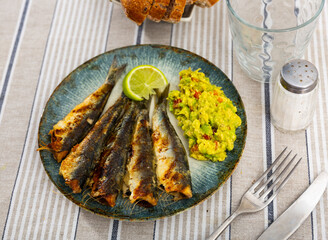 Delicious grilled sardines with guacamole and lemon